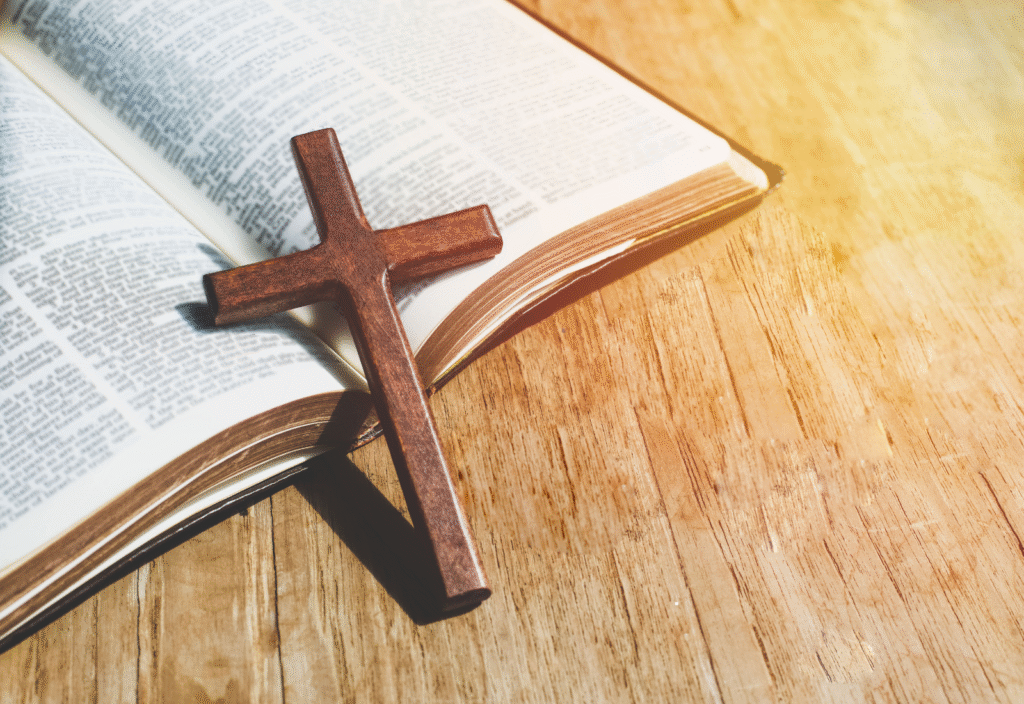 Image of a cross propped on an open scripture book