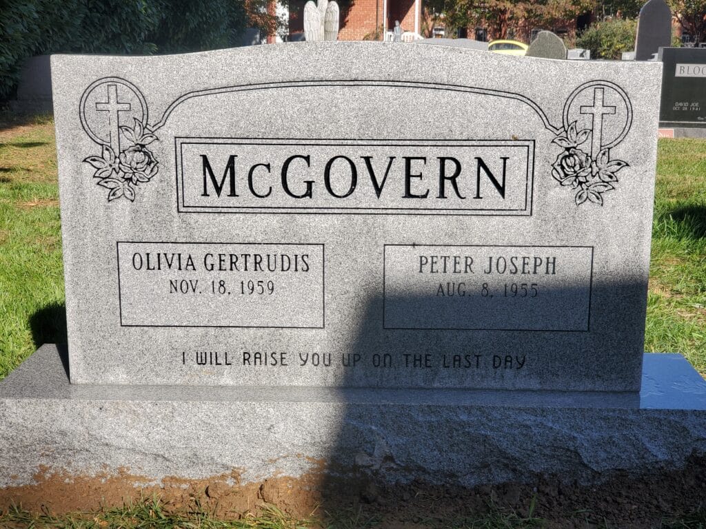 double monument with carved cross and floral design