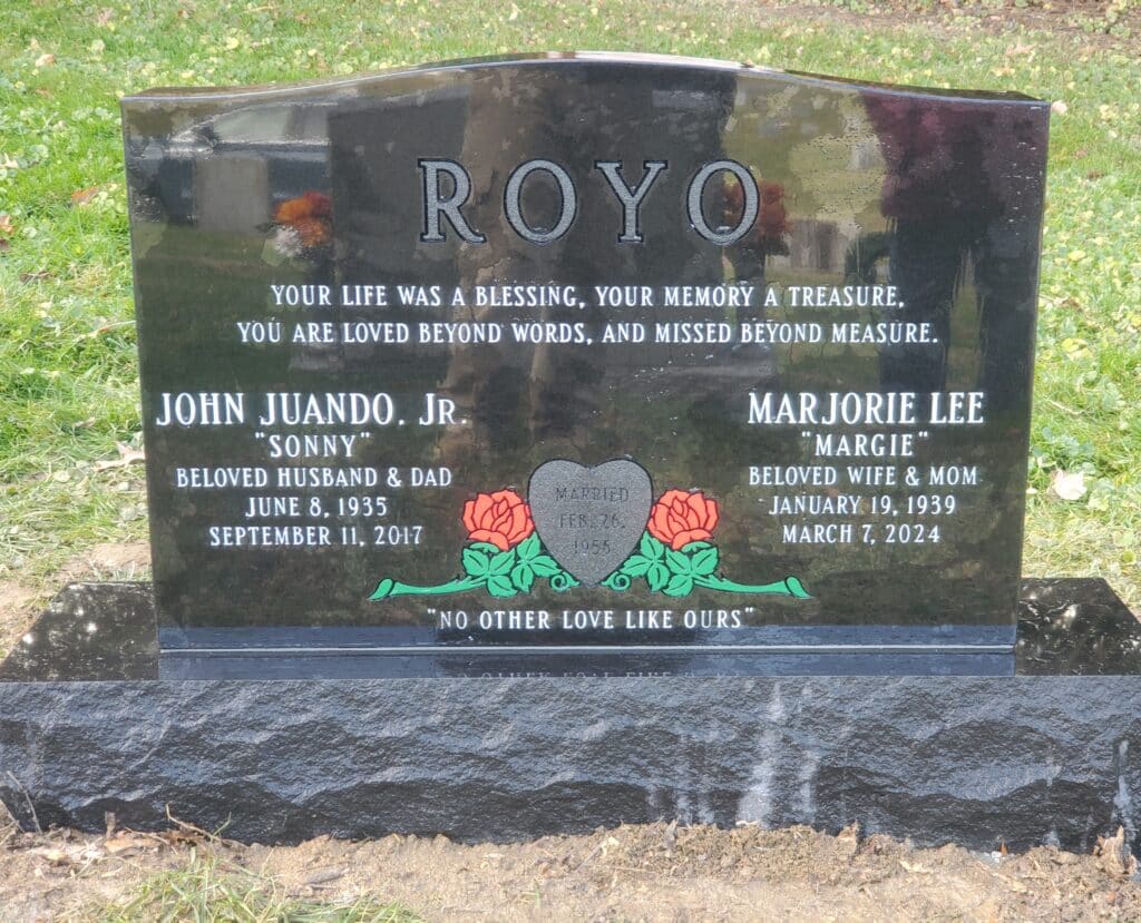 black double headstone with red roses