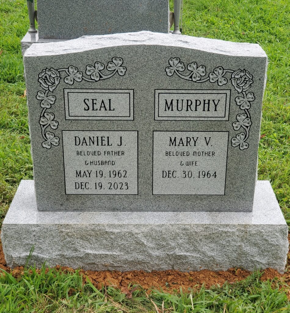 granite monument with two surnames and shamrocks