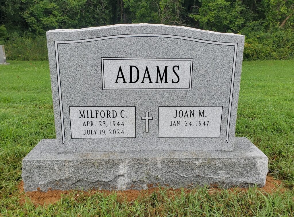 Two-name memorial with carved border and polished center