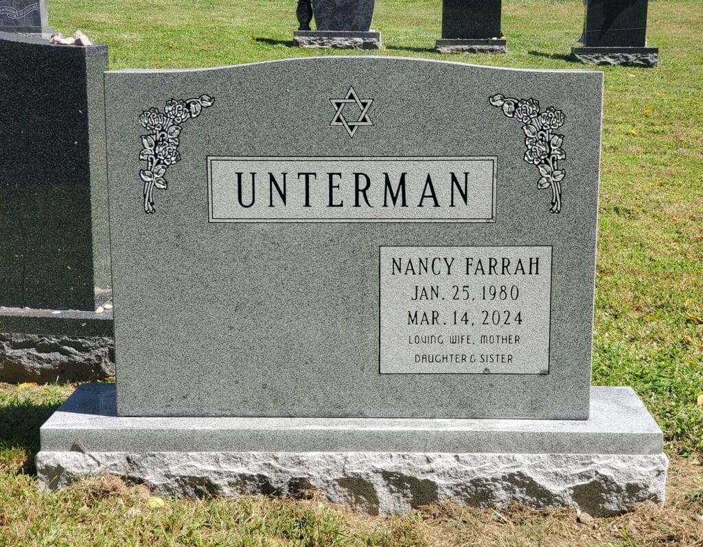 Double monument featuring Star of David and rose carvings