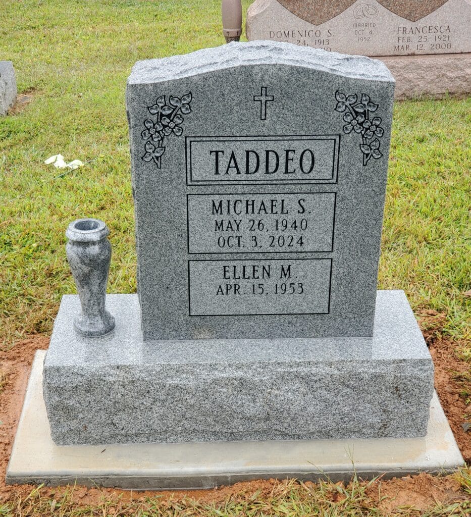 double interment monument with floral design and latin crfoss